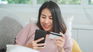 young-smiling-asian-woman-using-smartphone-buying-online-shopping-by-credit-card-while-lying-sofa-when-relax-living-room-home-lifestyle-latin-hispanic-ethnicity-women-house-concept-2