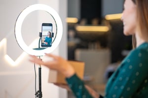 young-smiling-beauty-coach-presenting-new-beauty-products-online-audience